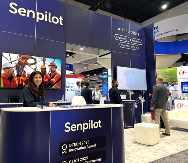 A smiling teammate at Senpilot's AI for Utilities exhibition booth